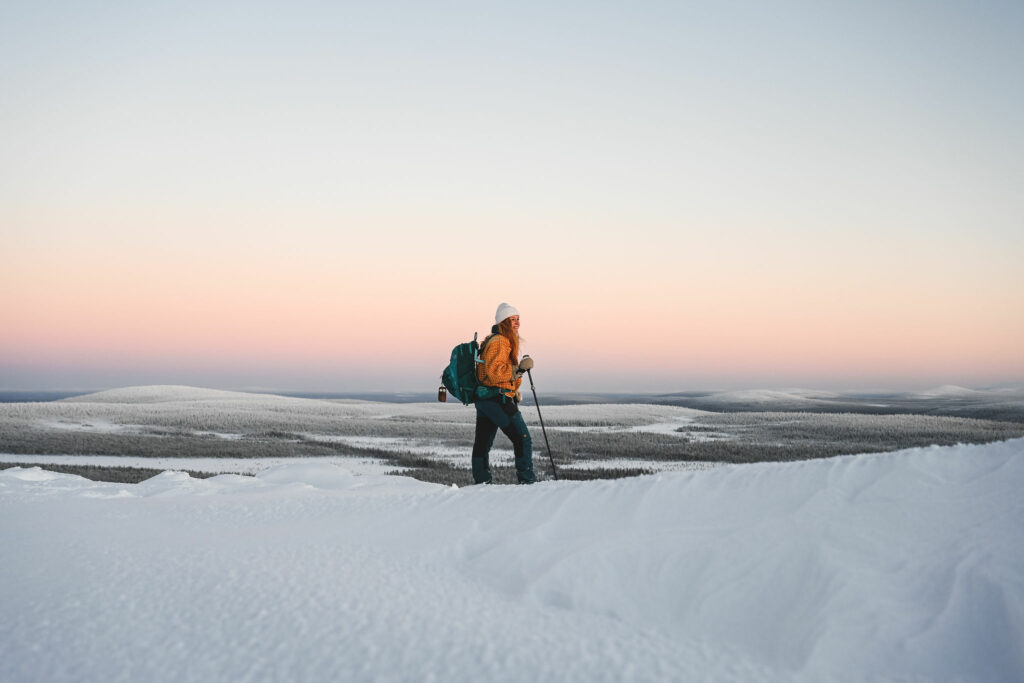 Kuvassa kuvataiteilija Jonna Kalliomäki lumisessa Riisitunturin maisemassa